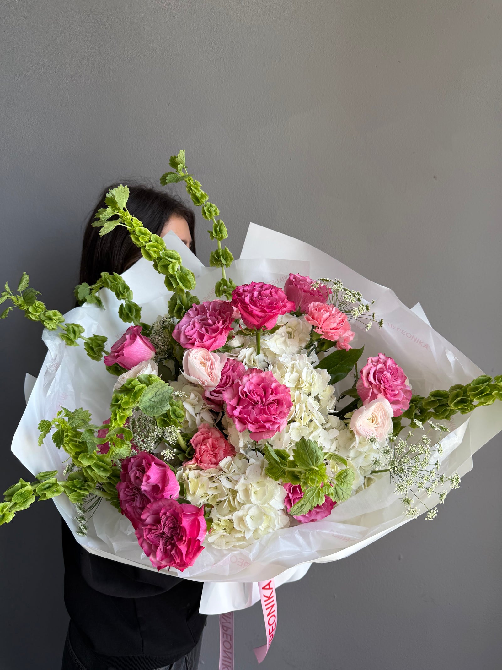 Bouquet “Jungle Flamingo” - peony roses, ranunculus, bells of Ireland, dianthus