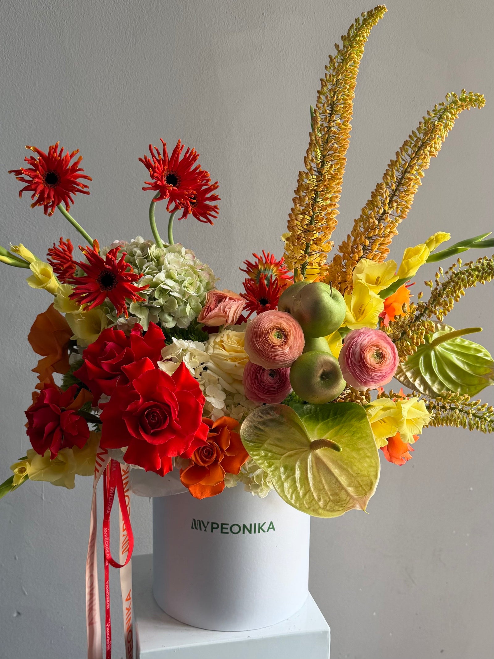 Flower Box “Object of Desire” — ranunculus, rose, anthurium, hydrangea, gerberas, decorative apple