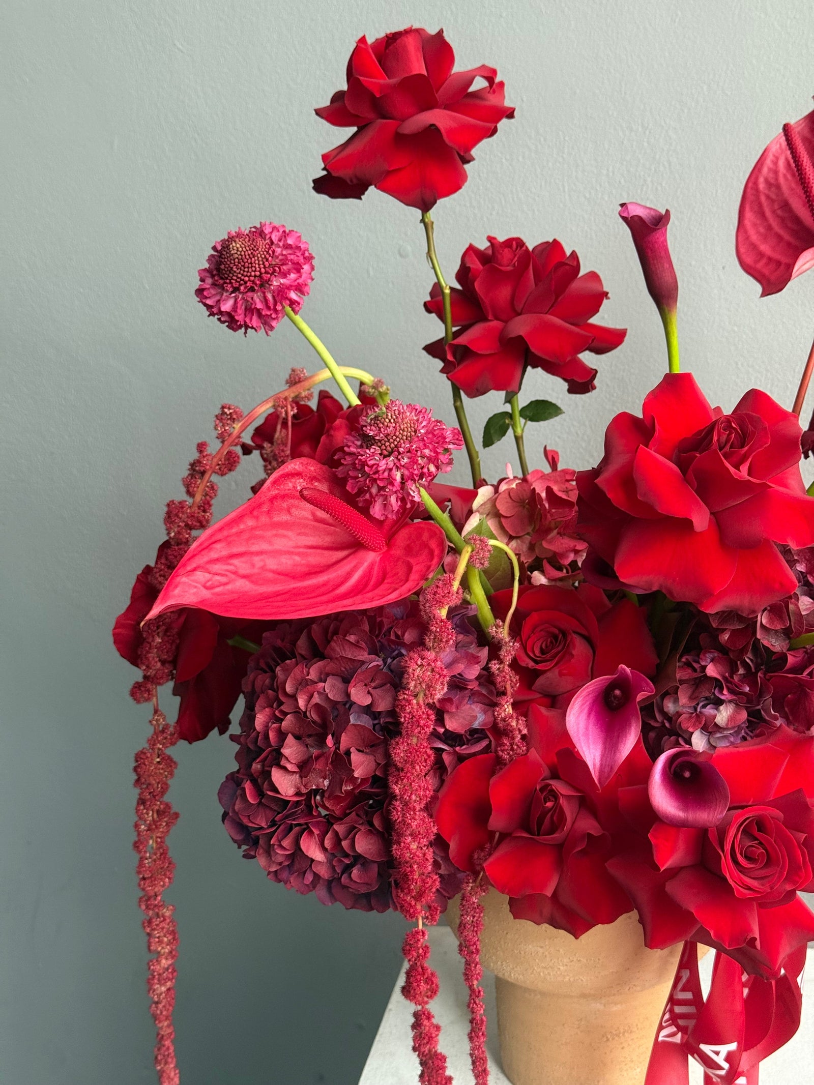 Flower Arrangement in a pot “Terracotta Flame” — anthurium, amaranth, calla lilies, roses