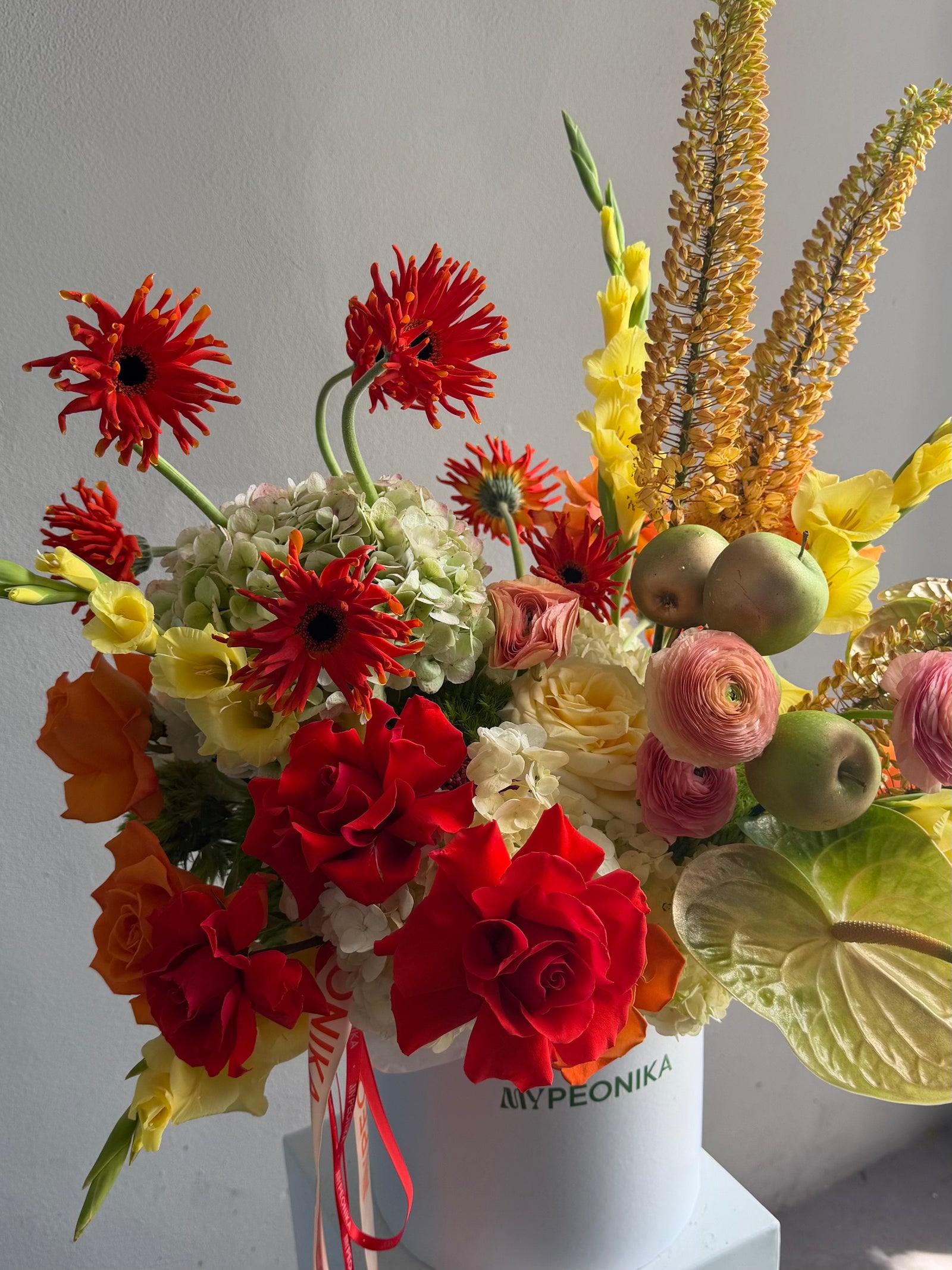 Flower Box “Object of Desire” — ranunculus, rose, anthurium, hydrangea, gerberas, decorative apple