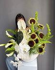 Interior Arrangement “Modern Muse” — orchid, anthurium, sunflower, calla lilies