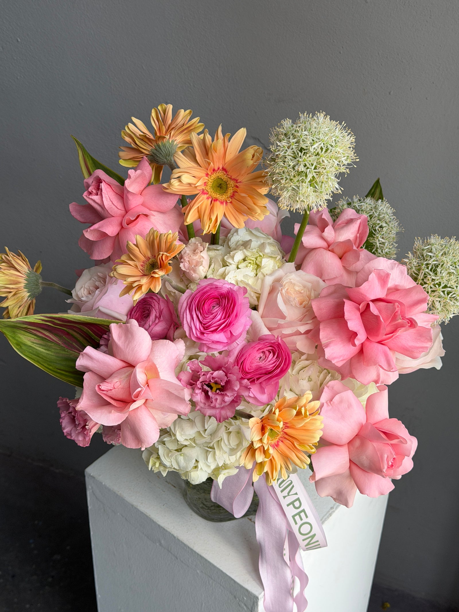 Vase Arrangement “Living in Color” — hydrangeas, gerberas, roses, lisianthus, allium, ranunculus