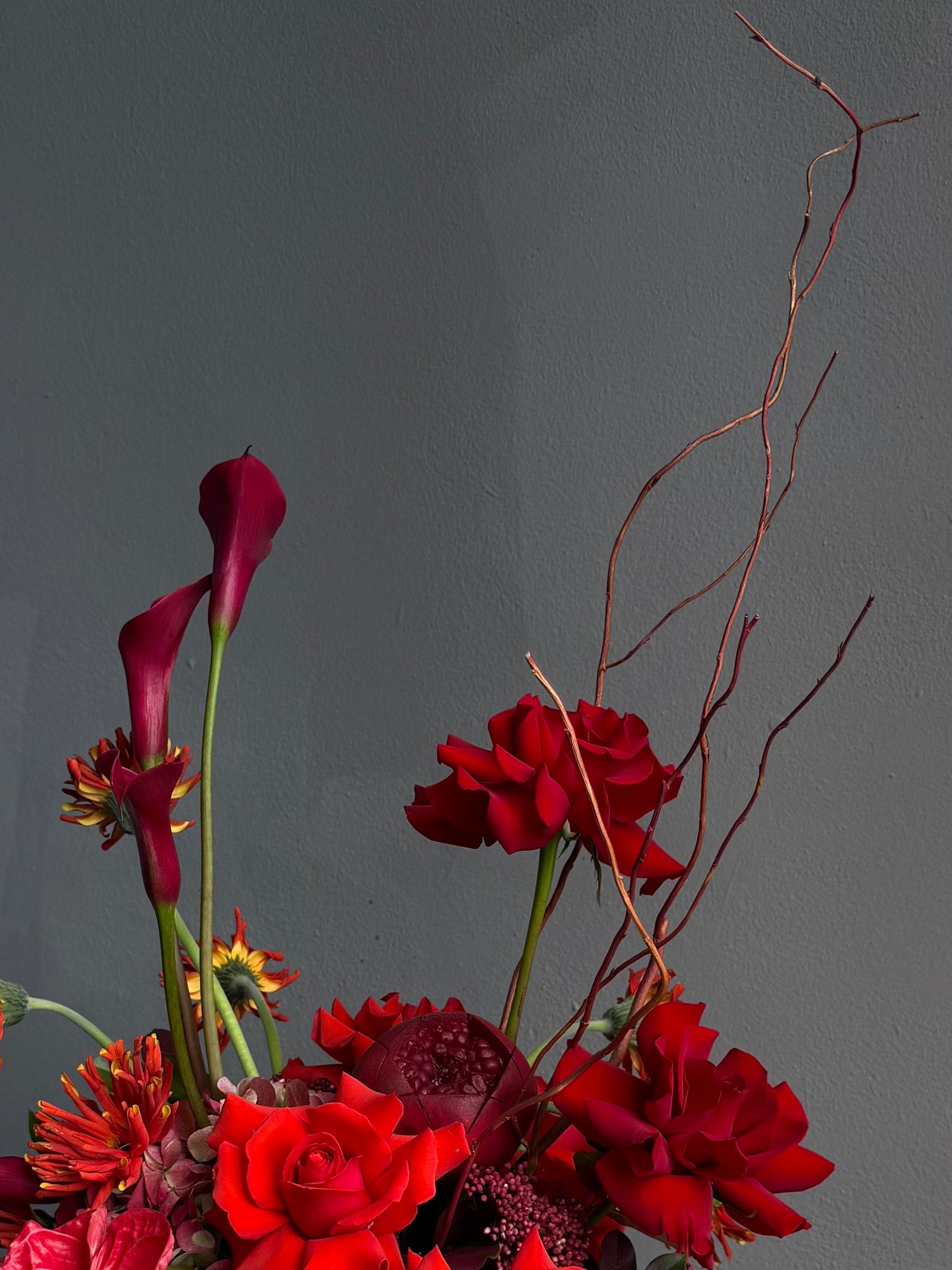 Vase Arrangement “Burning Love” — roses, hydrangea, anthurium, calla lily, gerberas, decorative pomegranate