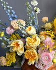 Flower Basket “Hello, Sunshine!” — ranunculus, roses, delphinium, carnations, mimosa & seasonal blooms