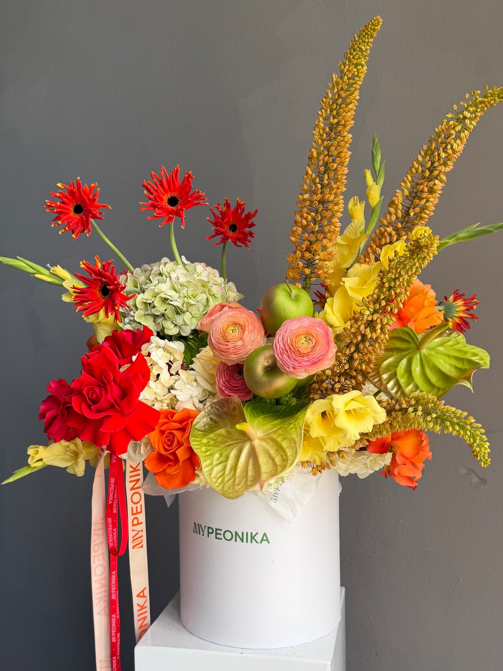 Flower Box “Object of Desire” — ranunculus, rose, anthurium, hydrangea, gerberas, decorative apple