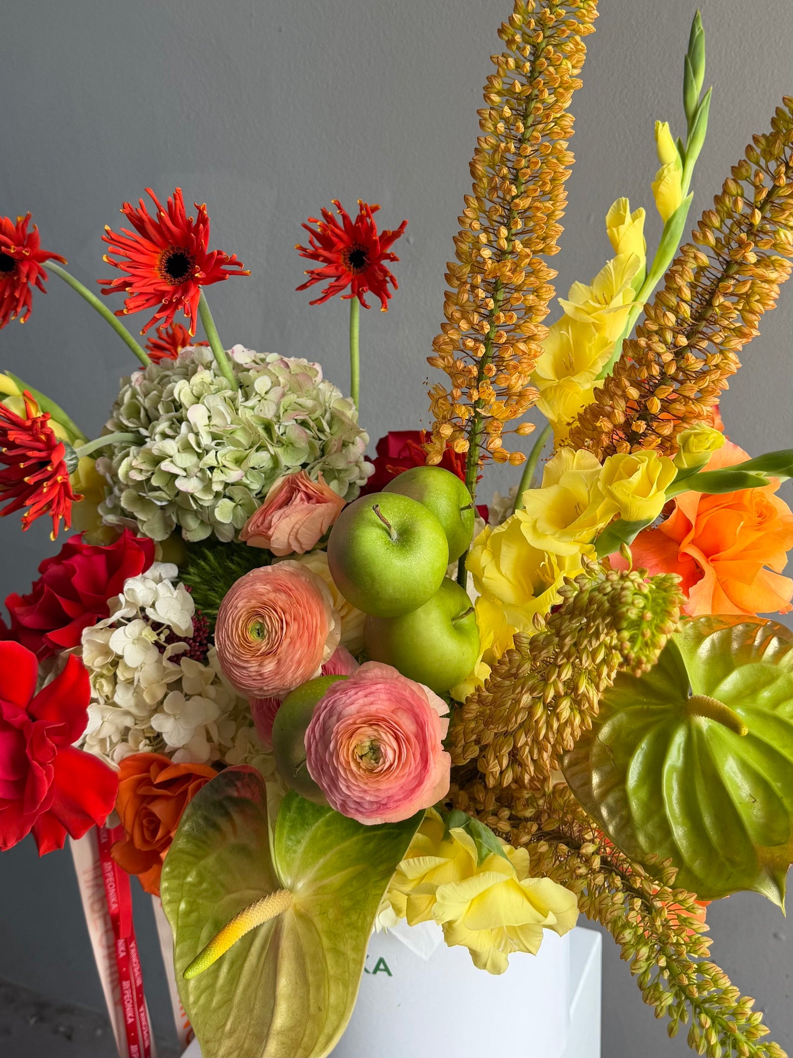 Flower Box “Object of Desire” — ranunculus, rose, anthurium, hydrangea, gerberas, decorative apple