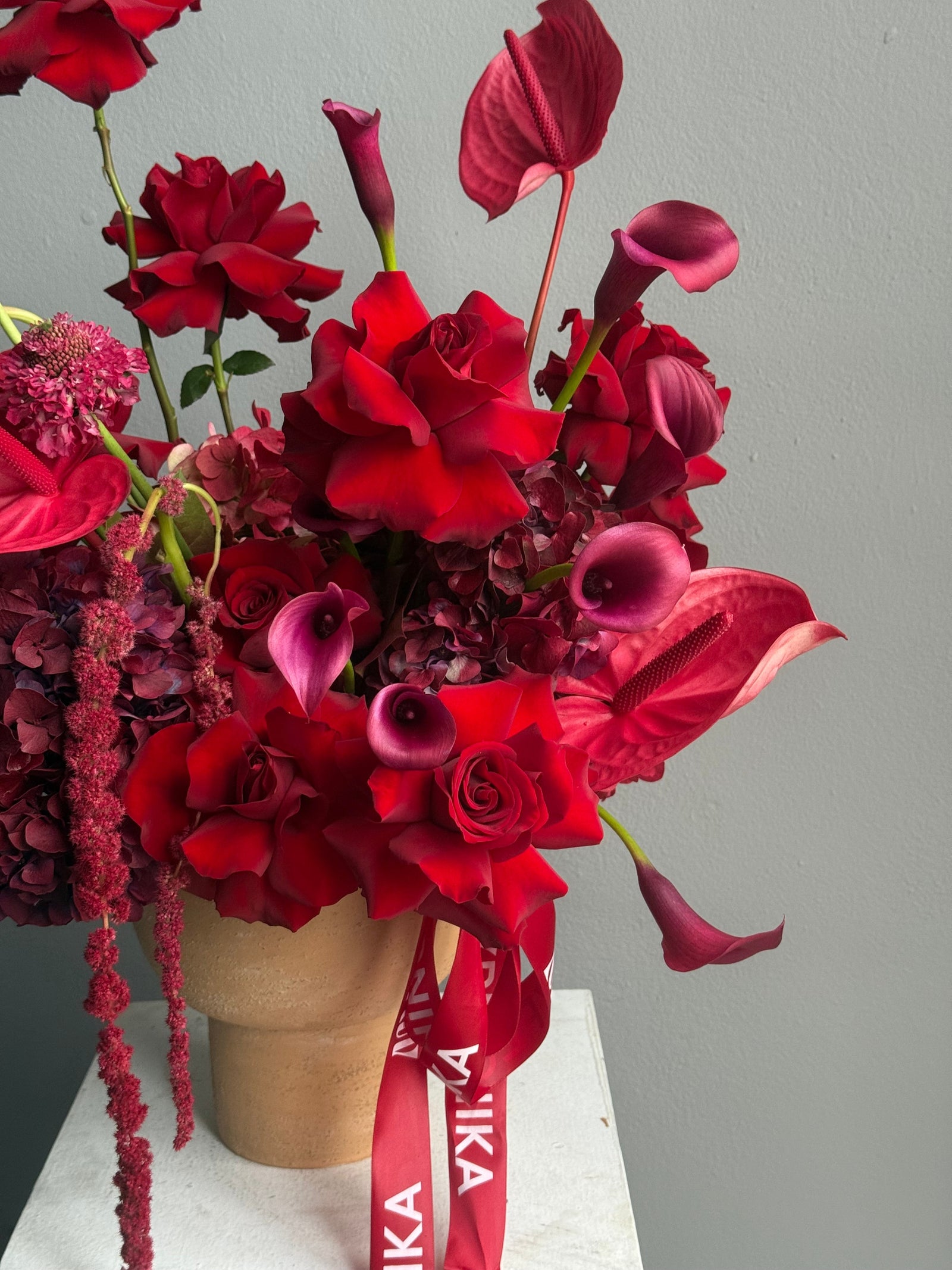Flower Arrangement in a pot “Terracotta Flame” — anthurium, amaranth, calla lilies, roses