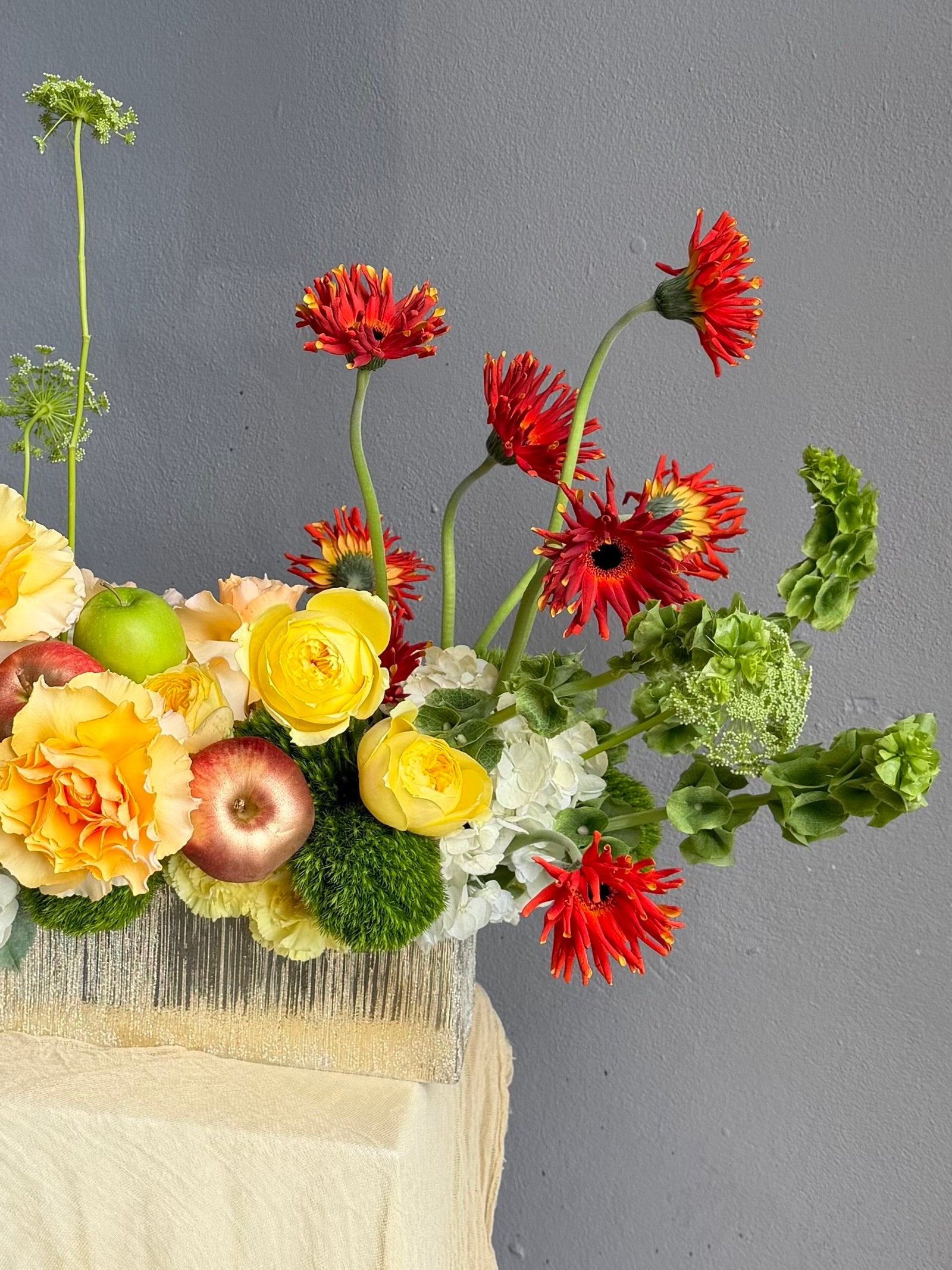 Vase Arrangement “No Beige” — gerberas, roses, green dianthus, hydrangea, viburnum, molucella, decorative apple