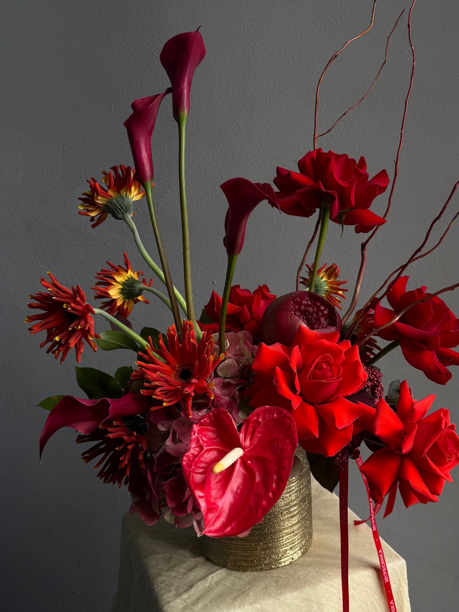 Vase Arrangement “Burning Love” — roses, hydrangea, anthurium, calla lily, gerberas, decorative pomegranate