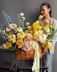 Flower Basket “Hello, Sunshine!” — ranunculus, roses, delphinium, carnations, mimosa & seasonal blooms