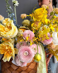 Flower Basket “Hello, Sunshine!” — ranunculus, roses, delphinium, carnations, mimosa & seasonal blooms