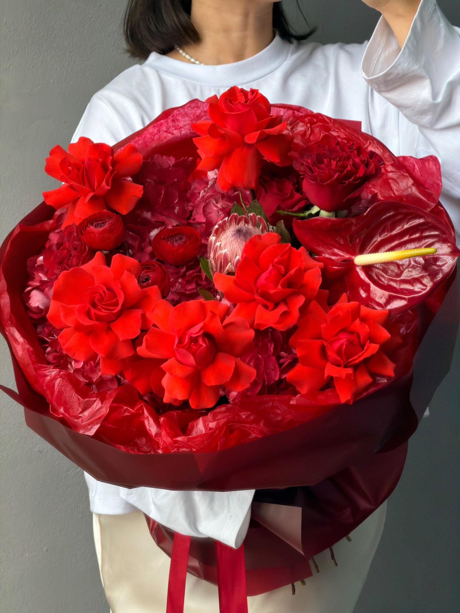 Bouquet “Kiss attack” — king protea, ranunculus, anthurium, rose